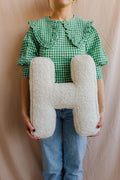 Boucle Letter Cushion H Teddy Letter Pillow by Bettys Home held by woman in green shirt 