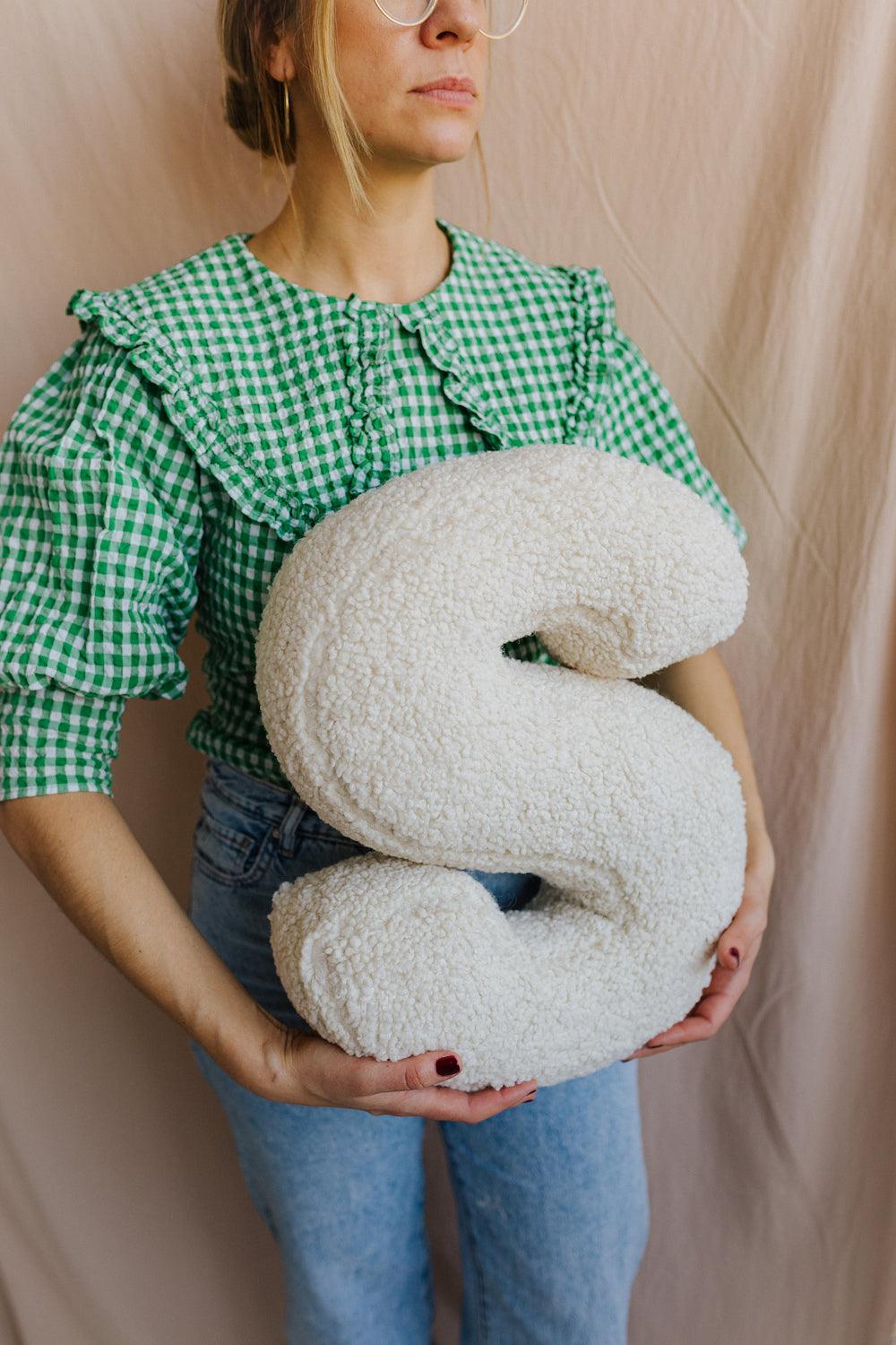 Boucle letter cushion S teddy pillow by bettys home held by woman in green shirt baby shower gift idea