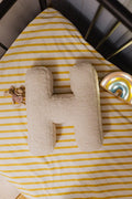 Boucle letter cushion H teddy pillow by bettys home lying in kids crib next to maileg mouse as kids room decoration idea